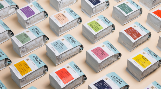 Bags of good citizen coffee on flat lay background