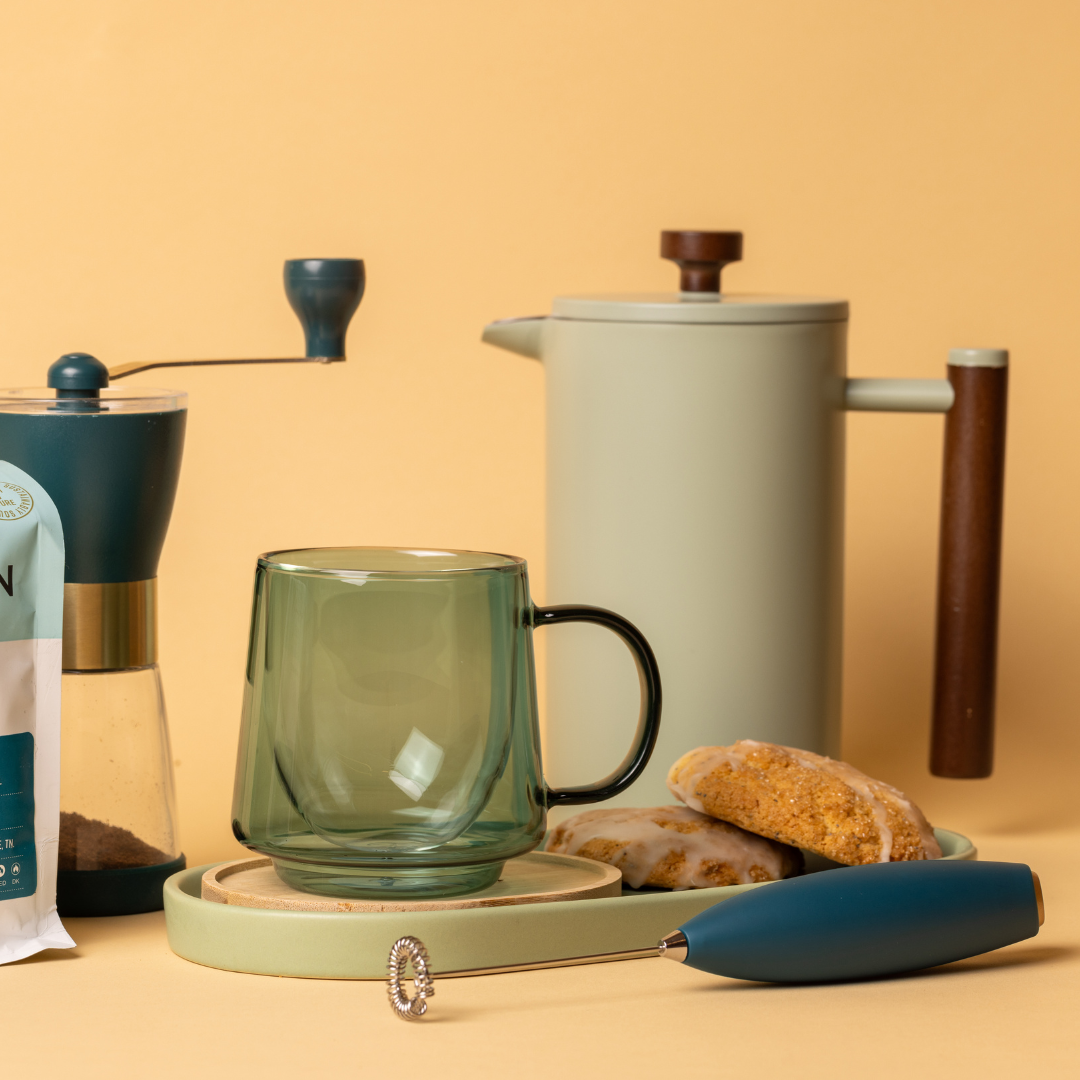 french press with mug and other accessories'