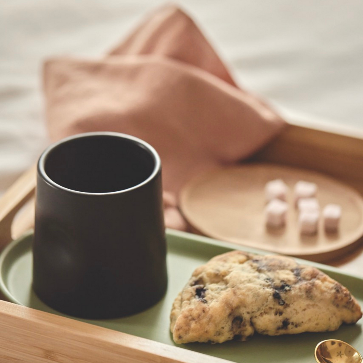 tray with coffee and a scone on it