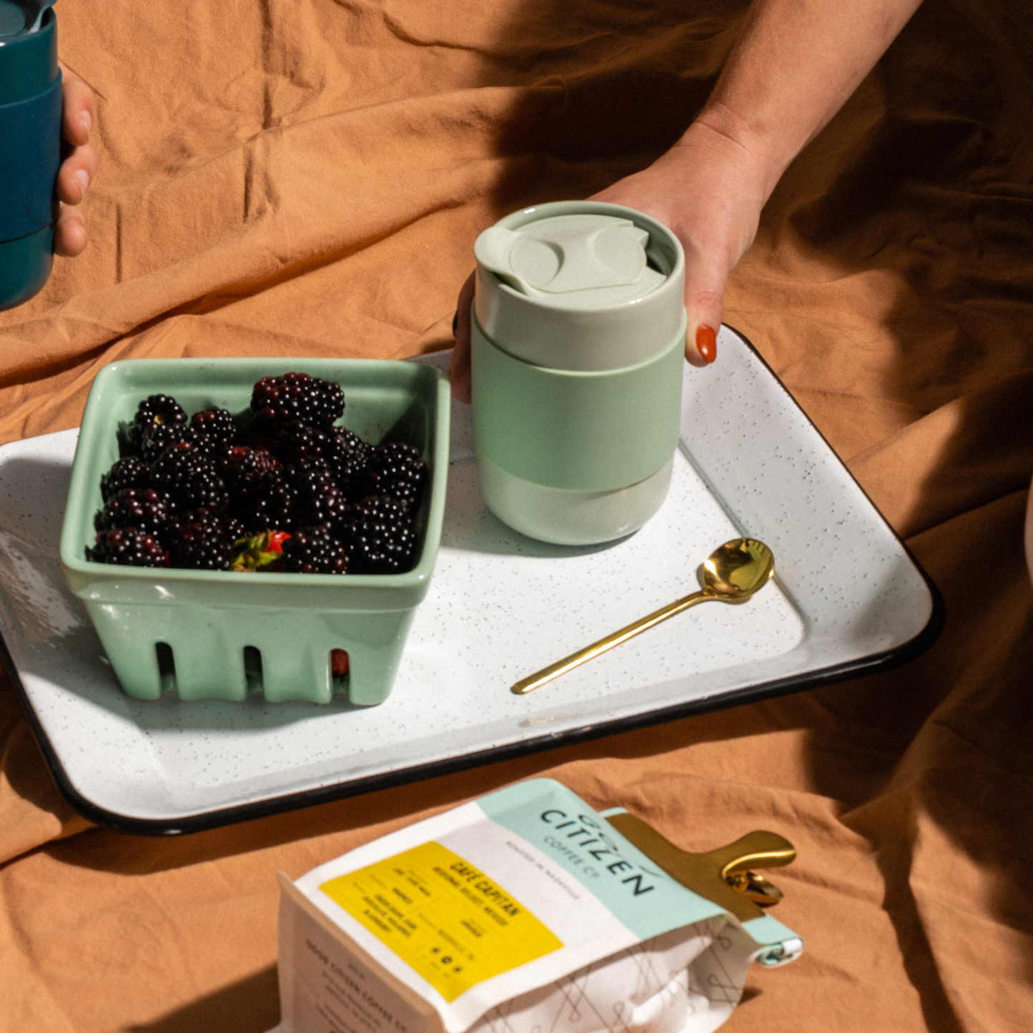 tumbler next to berries and a spoon