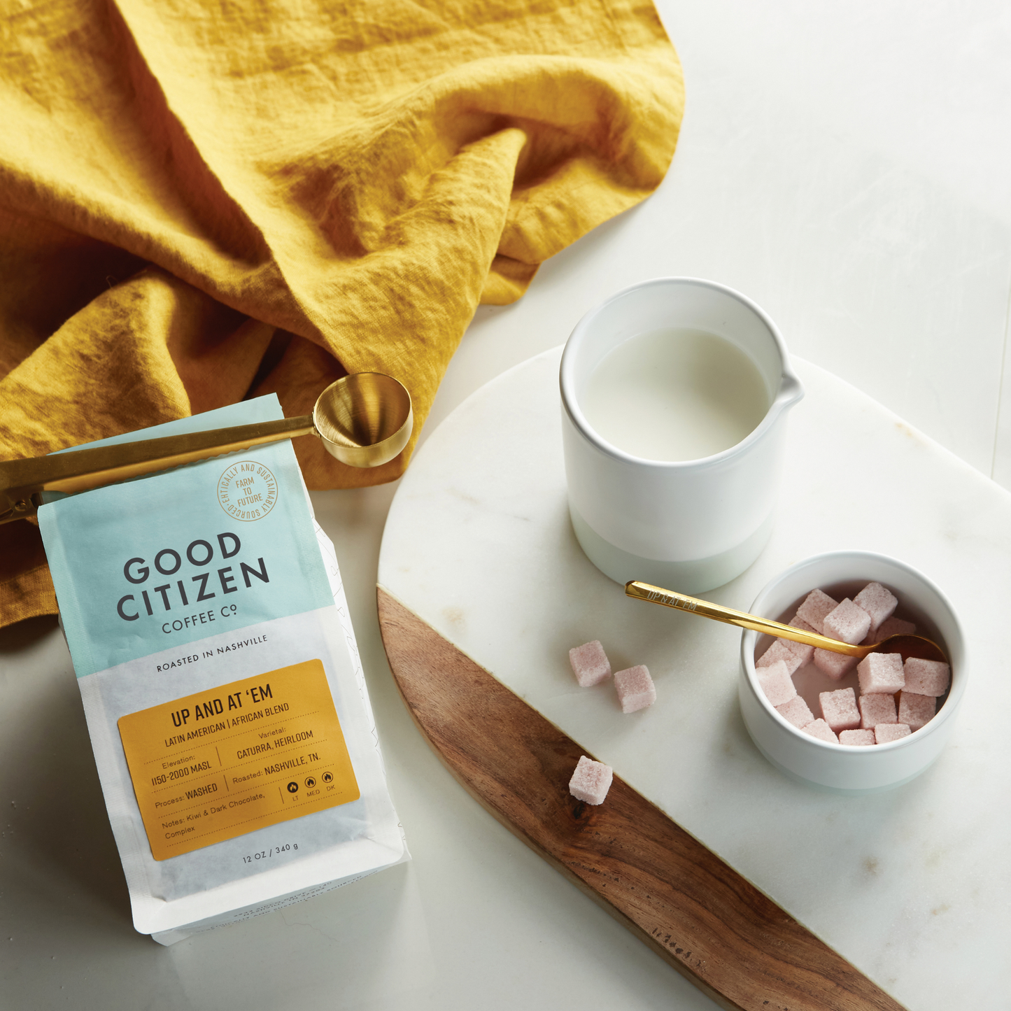sugar cubes next to cream and a coffee bag