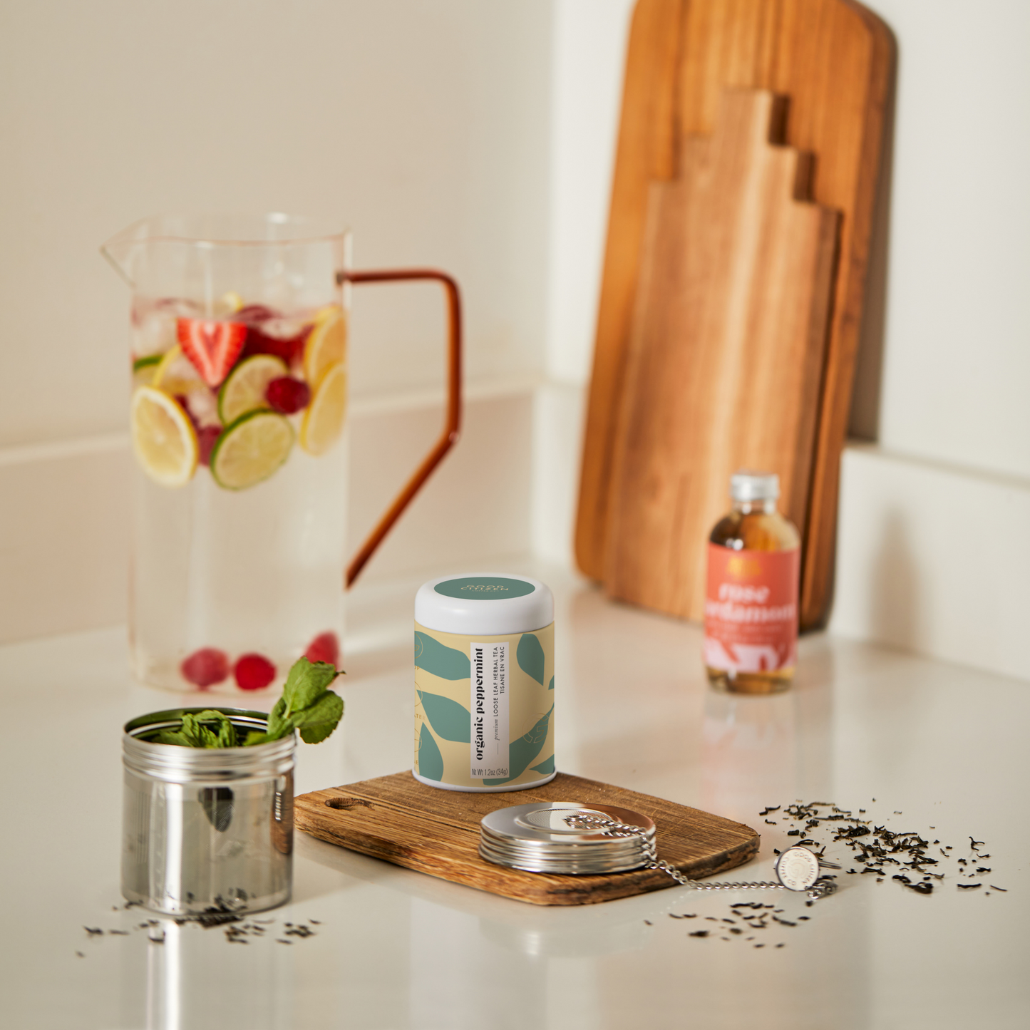 tea pitcher with tea and infuser next to each other