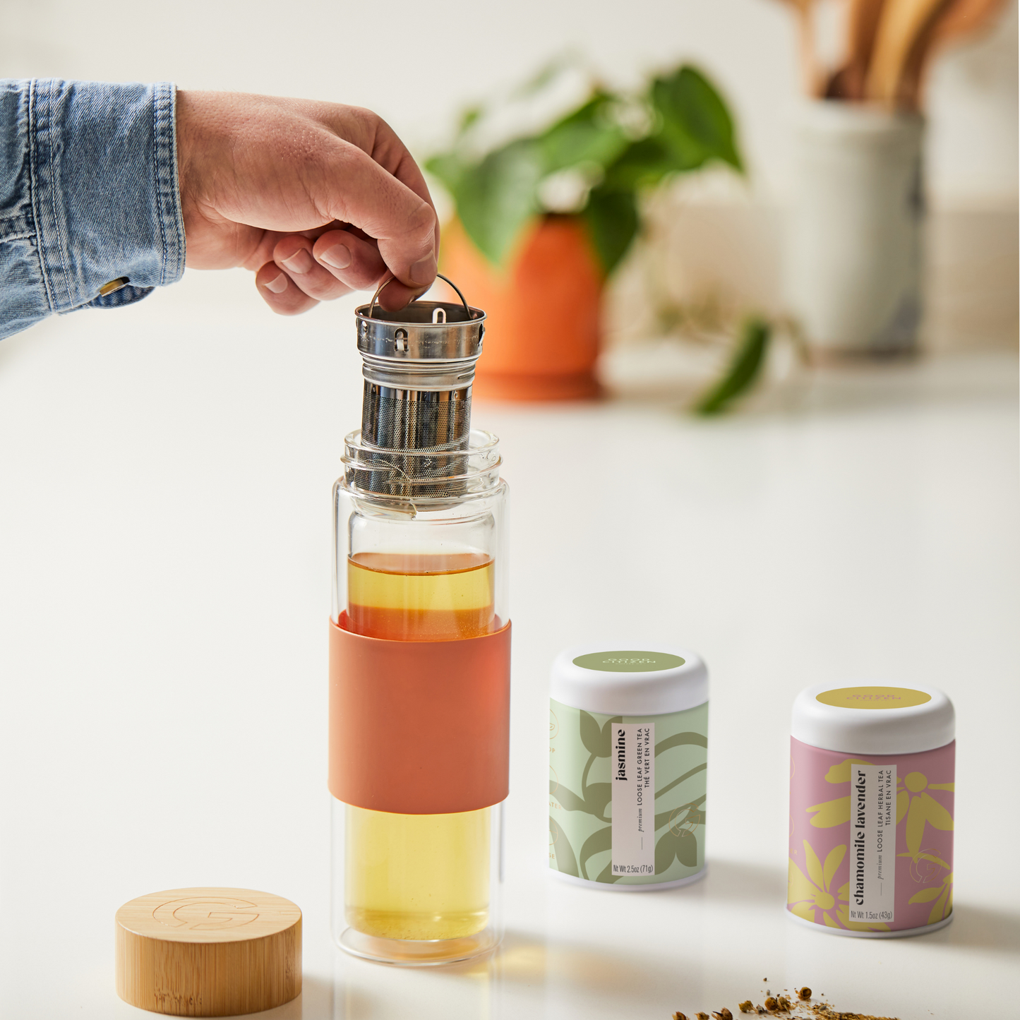 tea tumbler with tea inside of it and next to it