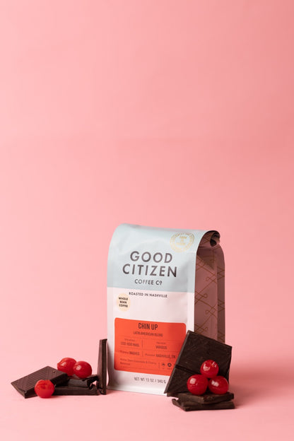 coffee bag with chocolate and cherries next to it