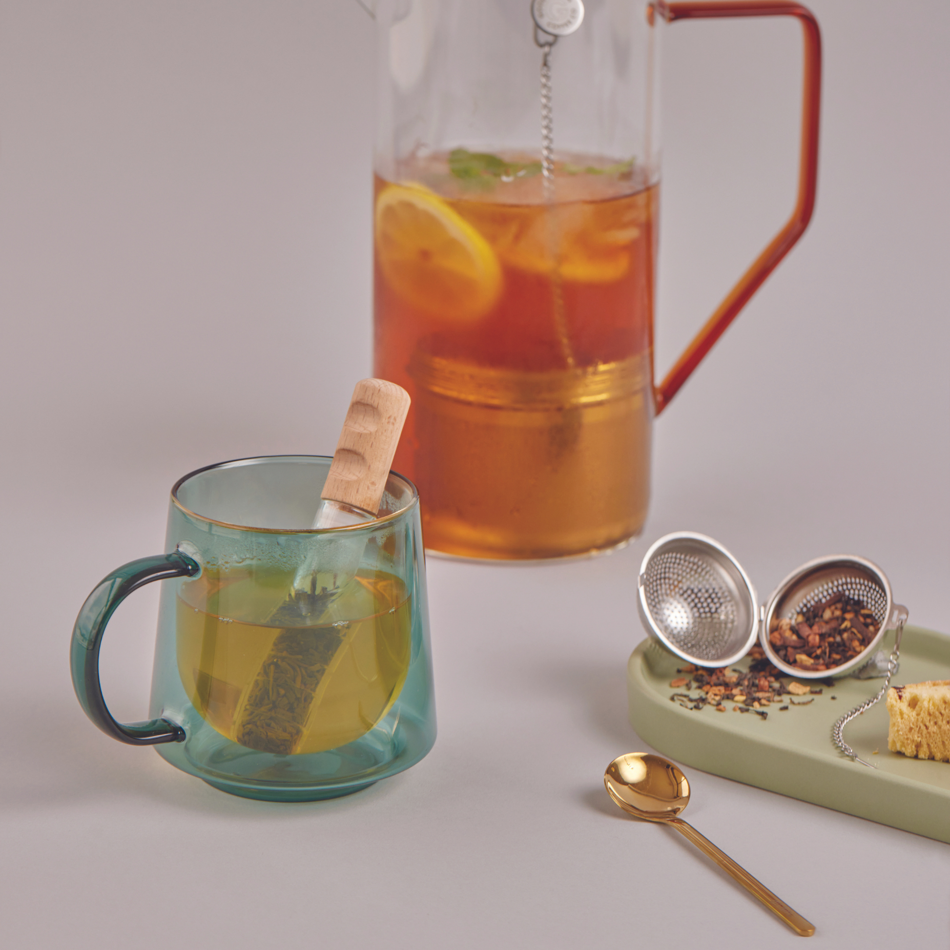 tea infuser next to a cup of tea