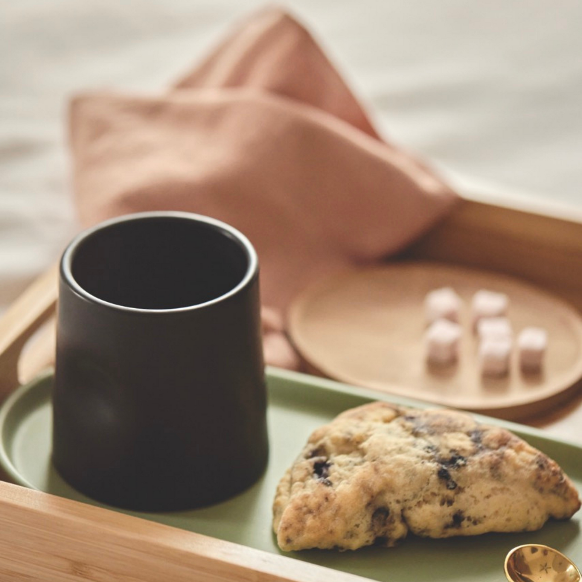 thumb mug on a nesting tray with a scone