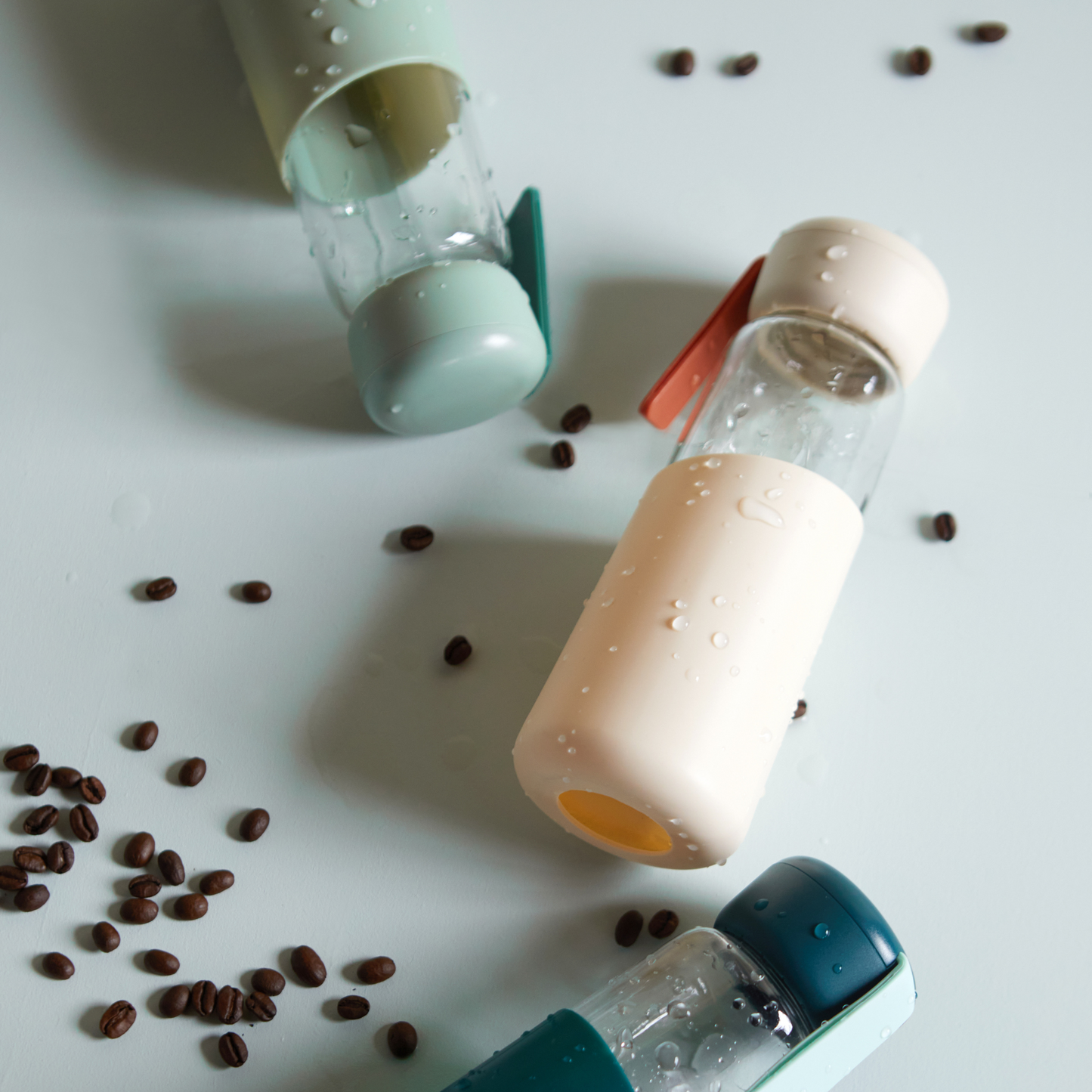 Glass tumblers with coffee beans surrounding them